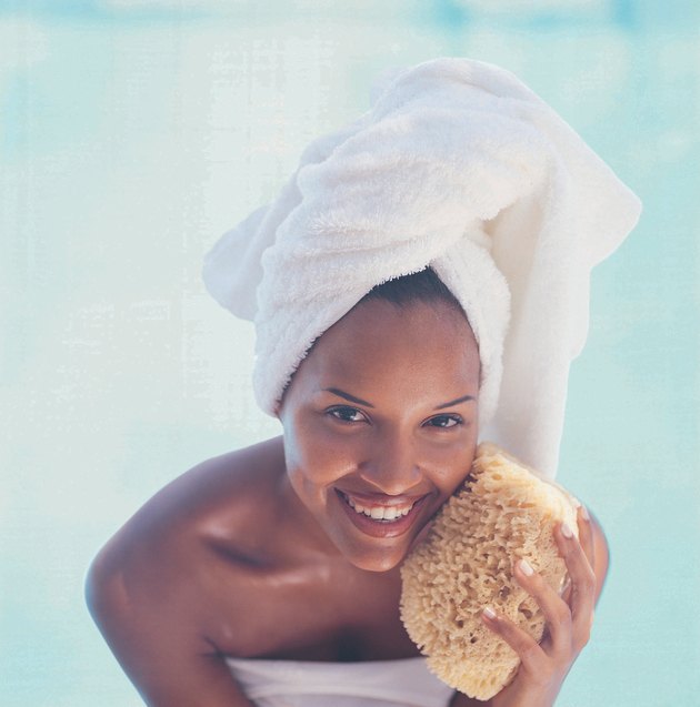 Woman Washing Face with a Sponge