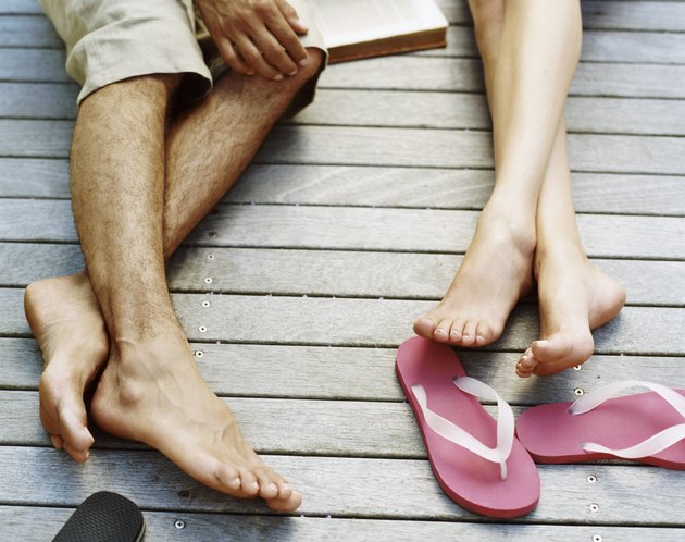 Low Section Shot of Couple Lying on Decking