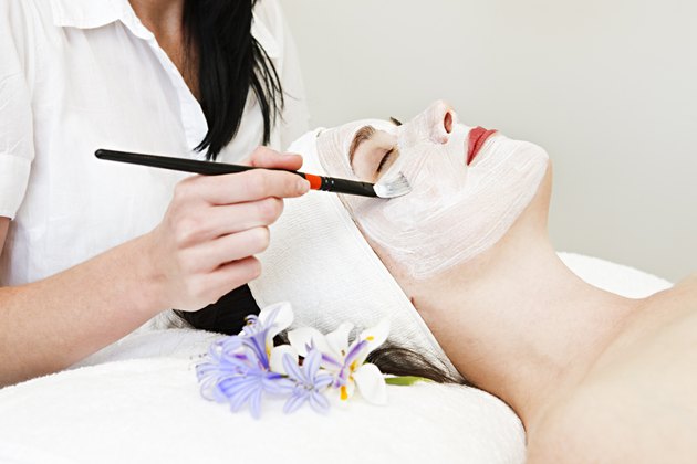 Beauty therapist paints facial mask