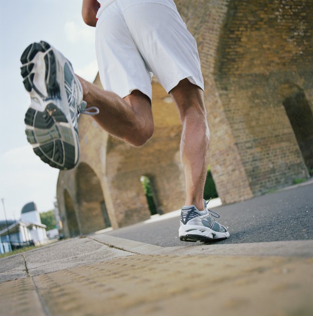 Man running towards bridge, low section