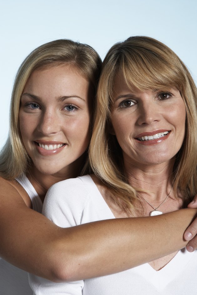 Mother and adult daughter smiling, portrait