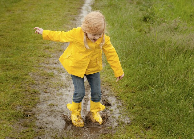 Girl Jumping in Mud Puddle