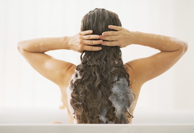 young woman washing hair. rear view