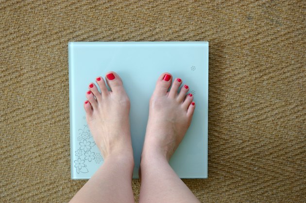 Woman weighing herself
