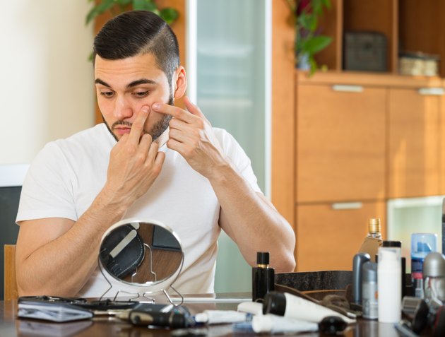 Man squeezing pimple
