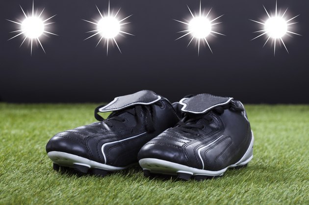 Soccer Shoes Lying On The Green Pitch