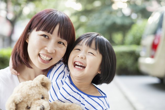 Mother and Daughter Embracing and Laughing