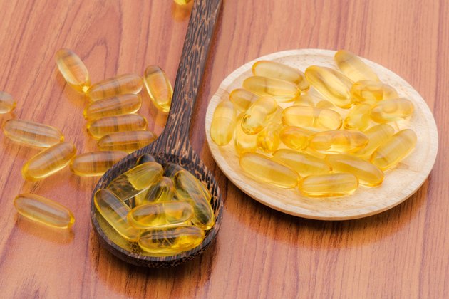 Fish oil omega3 with wooden spoon
