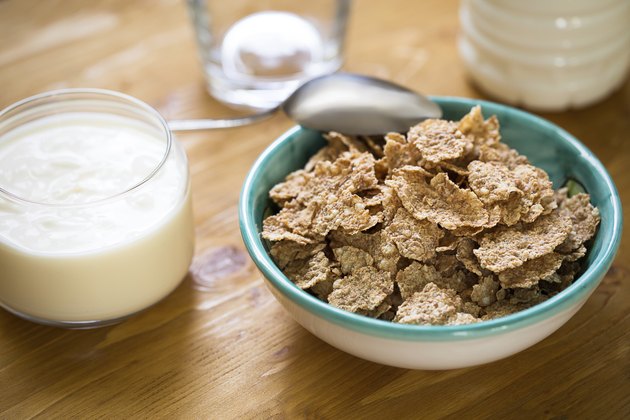 Delicious and healthy wheat flakes in bowl withy yogurt
