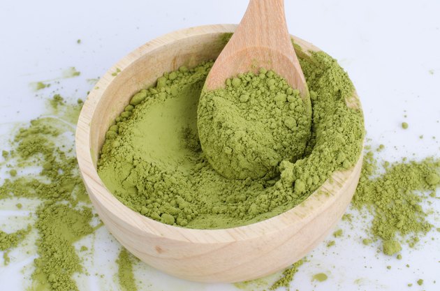 green powder heap isolated on white background