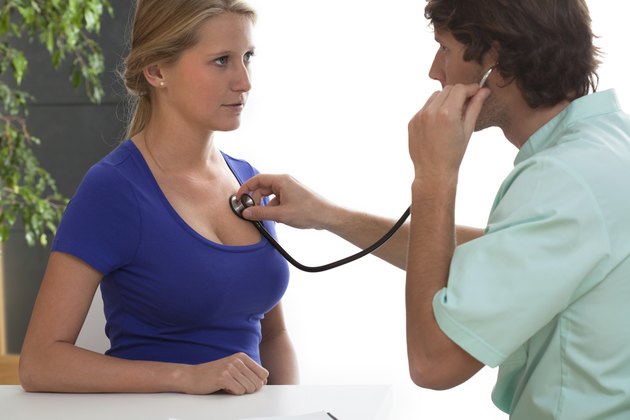 Cardiologist testing a patient