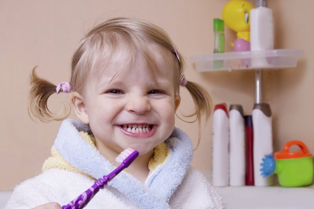 Girl showing her teeth in bathroom
