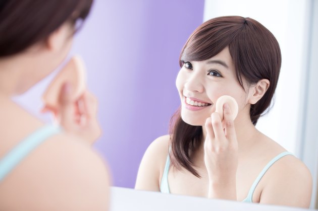 Smile woman with cosmetic sponge