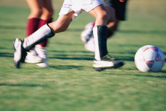 Close-up of soccer players feet and ball