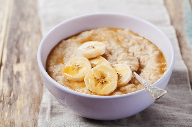 Bowl of oatmeal porridge with banana and caramel sauce