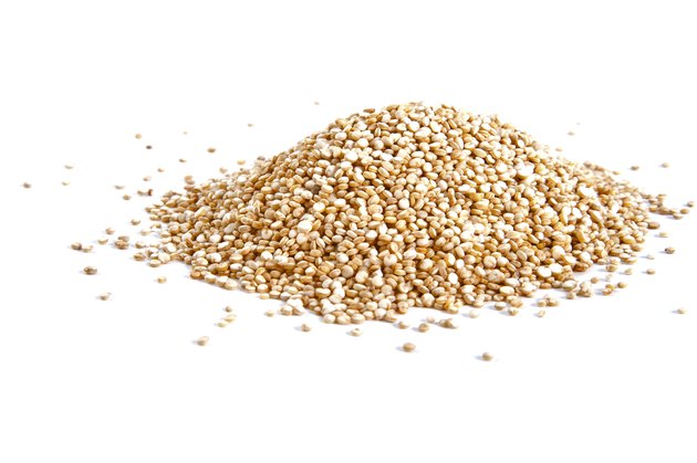 Handful of Quinoa on a white background.