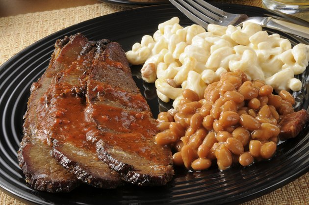 Closeup up of beef brisket with baked beans
