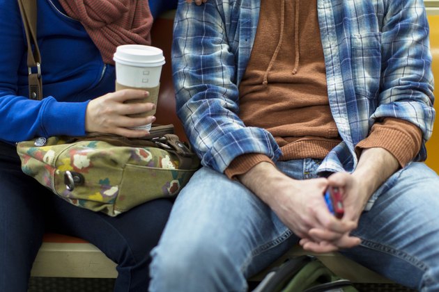 Couple sitting on urban subway