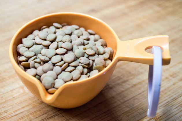 Green and Brown Lentils Portioned in a Measuring Cup