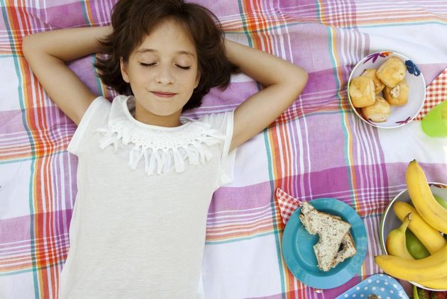 Overhead portrait of child girl with picnic