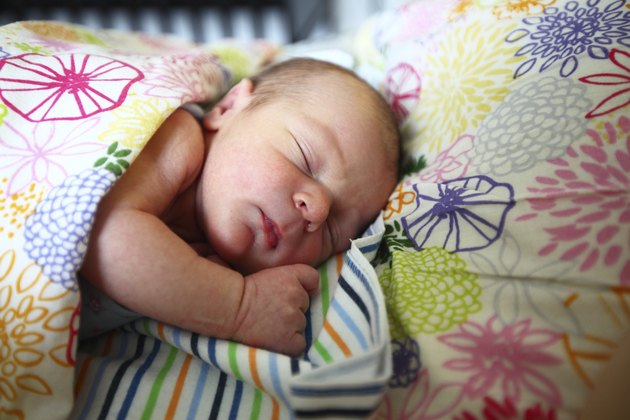 Infant sleeping on a bed