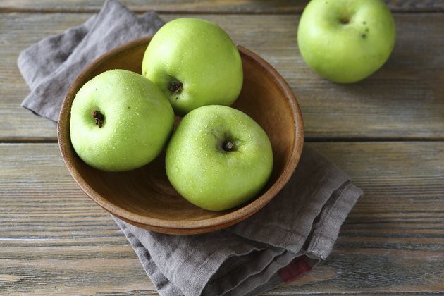 Ripe apple in a clay bowl