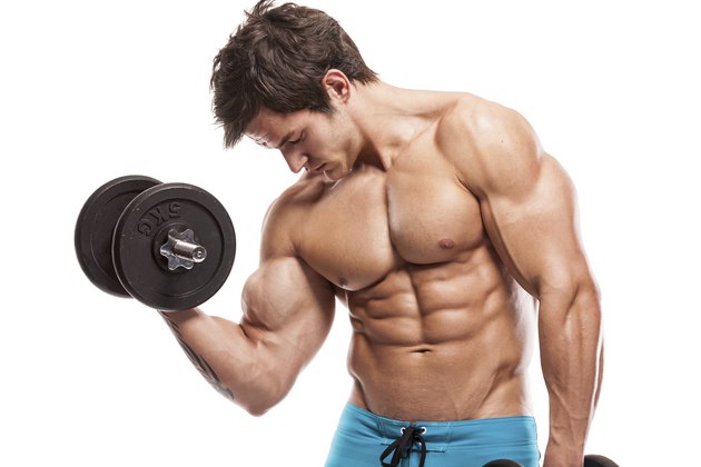 Muscular bodybuilder guy doing exercises with dumbbells over whi