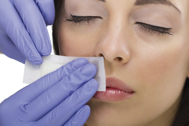 woman reciving facial epilation