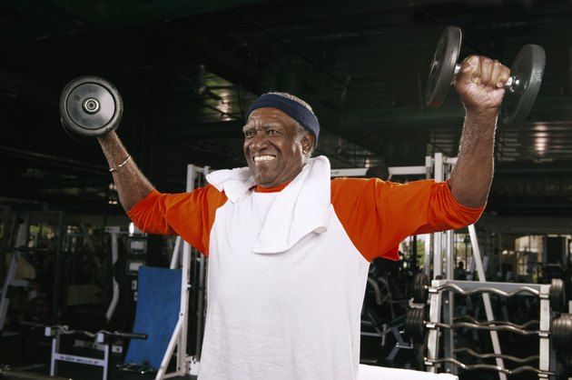 Senior man weight training in gym