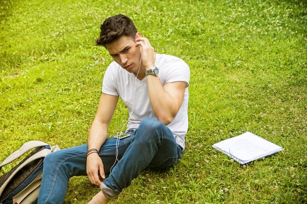 Young Man Listening to Music in Park