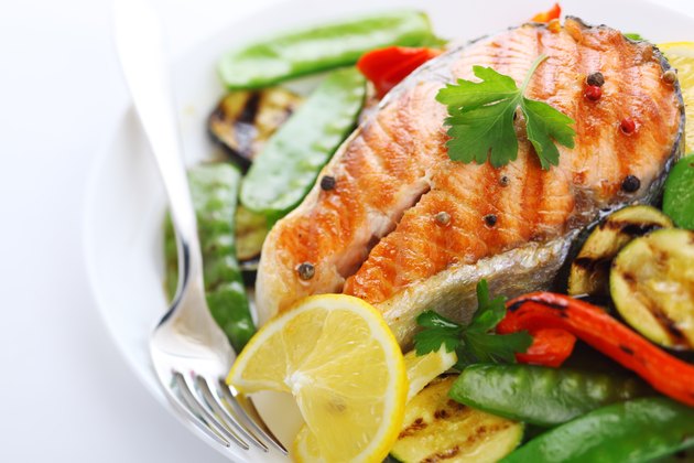 grilled salmon with vegetables on white plate