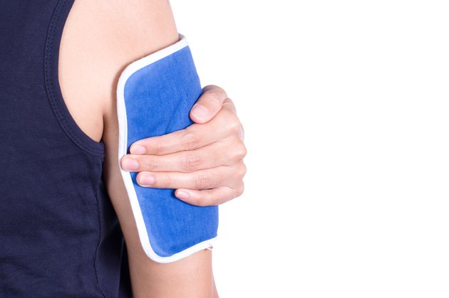 woman applying cold pack on her arm