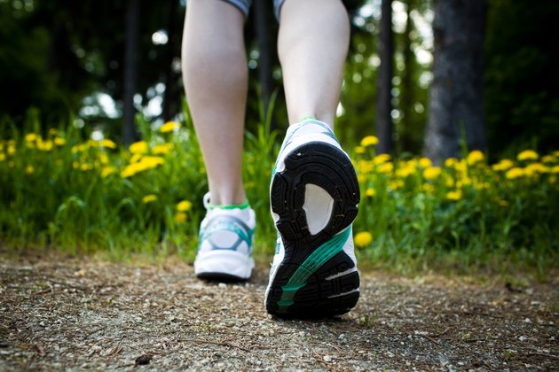 Woman walking cross country and trail in spring forest
