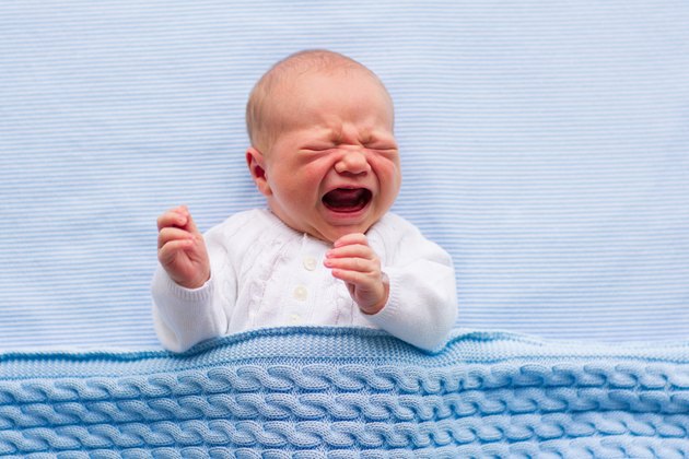 Newborn baby boy on a blue blanket