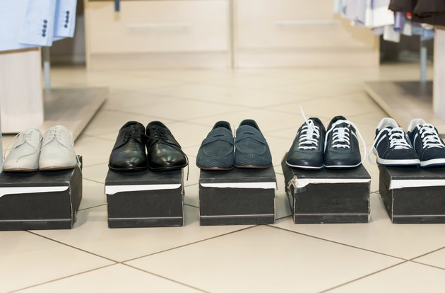 Men's shoes on black boxes.