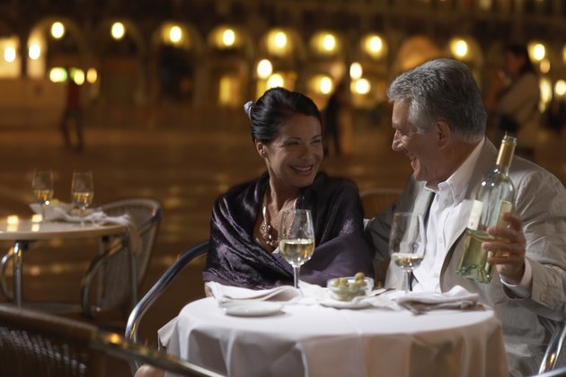 Italy, Venice, couple at restaurant table at night, outdoors