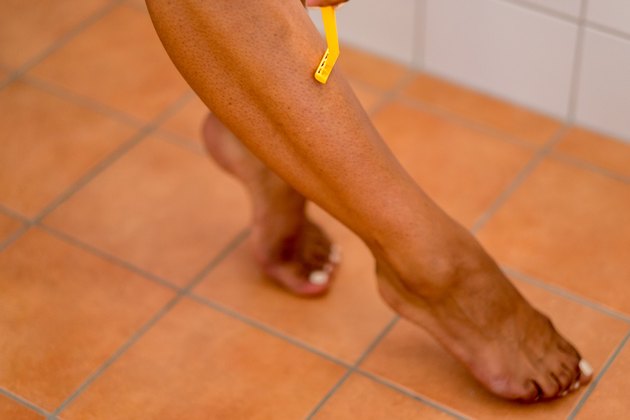 Woman Shaving Hair on her Leg Manually