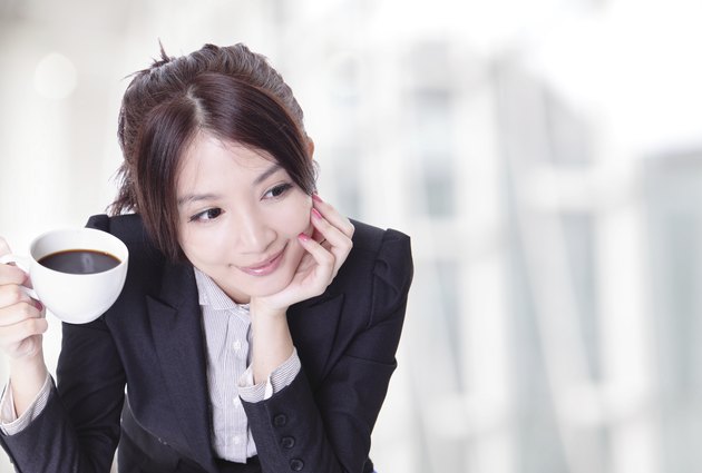 relaxed business woman holding a cup of coffee