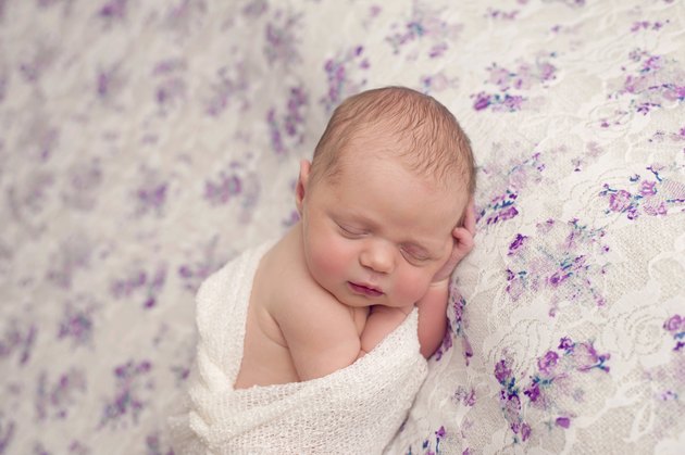Newborn Girl Sleeping in Swaddle