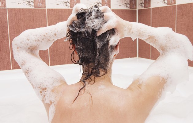 Beautiful girl under shower in bath room