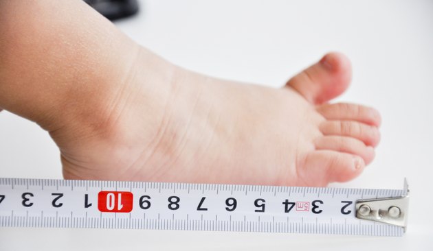 measuring feet to a baby