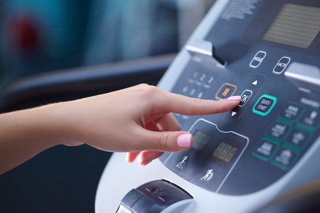 girl on a treadmill presses the button