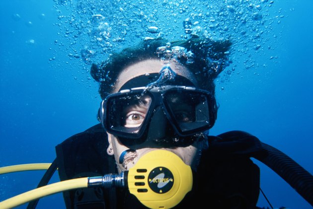 Man wearing scuba mask, underwater view, close-up