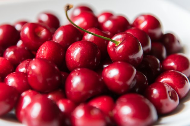 Bowl of red fresh cerries on a white background