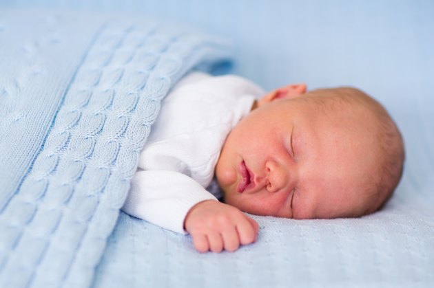 Newborn baby boy on a blue blanket