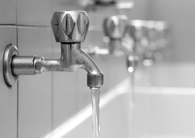 open faucets with water flowing in the bath changing rooms