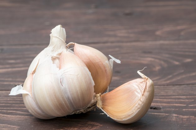 Organic garlic whole and cloves on the wooden background