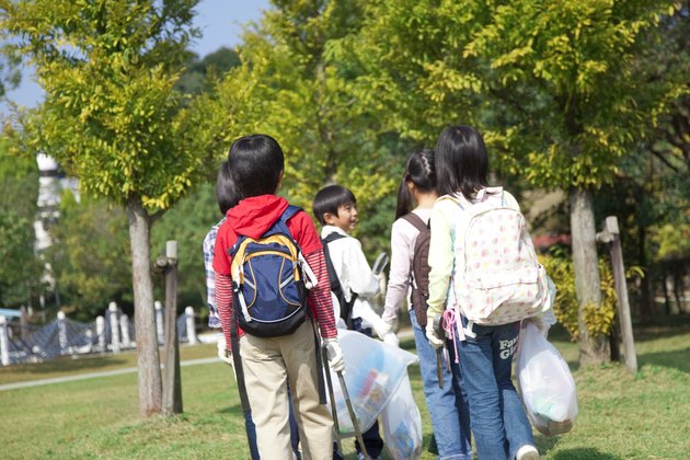 School children carrying bags for recycling