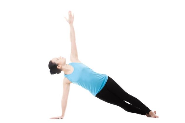 Sporty yogi girl doing exercises, Side Plank Pose, Vasisthasana, Yoga Pose, isolated on white background