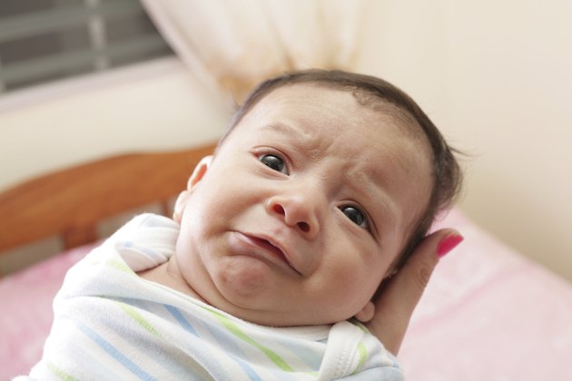 Woman holding a newborn crying